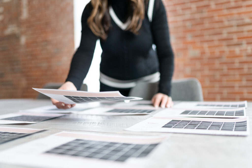 woman arranging pages of a calendar on a table
